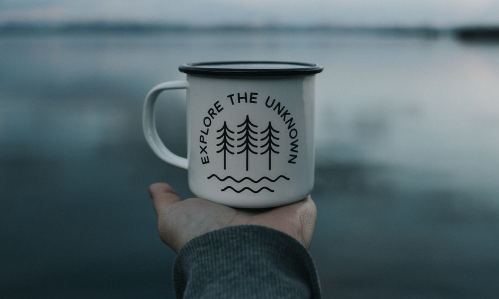 mug with a lake in the background
